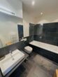 Exklusives Apartment im beliebten Wohnquartier "LE.GRAND" - Modernes Badezimmer mit Bad...